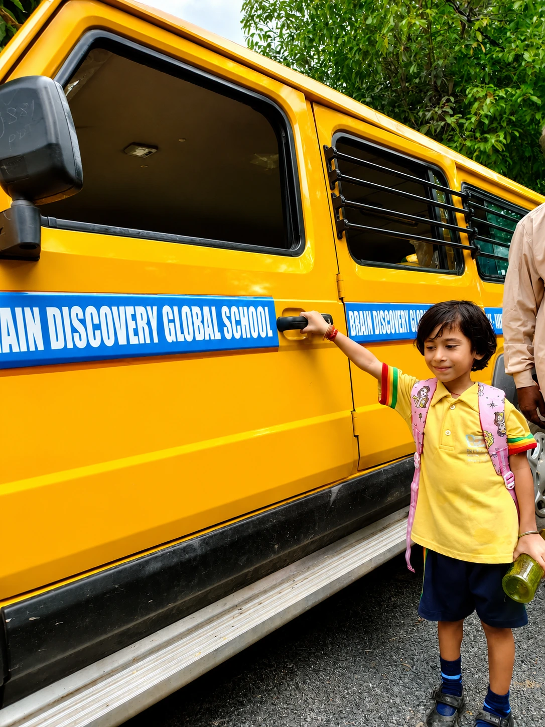A student beside the Brain Discovery Global School bus