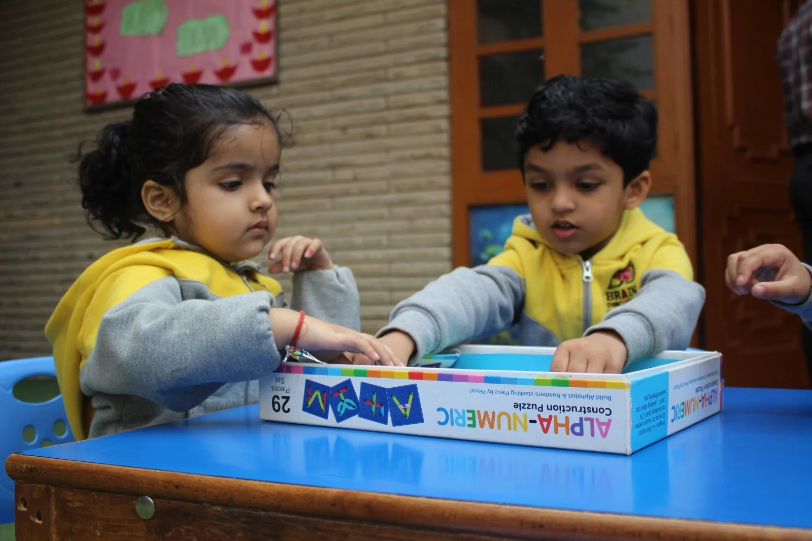Two students working together on an alphabet and number puzzle