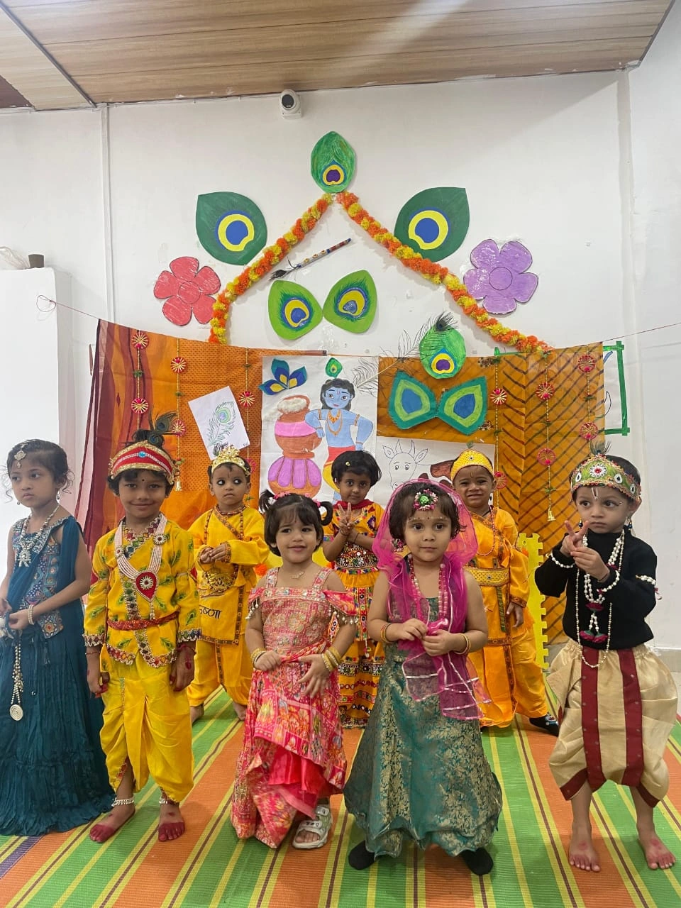 Students sharing a joyful moment during Janmashtami