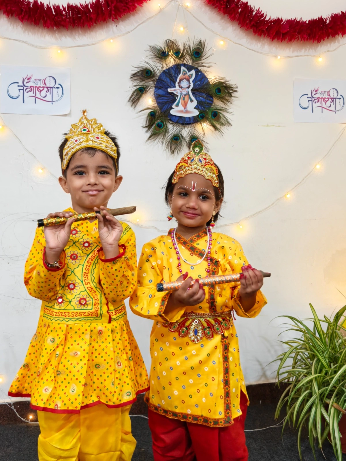 Two students dressed as Radha and Krishna with flutes